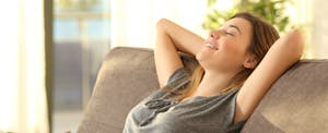 Woman relaxing because she can monitor her credit with Credit Karma
