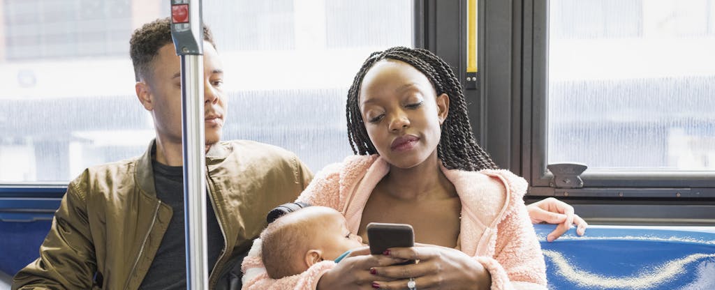 Young parents riding city bus and debating line of credit vs. loan