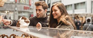 Couple paying for pastries at the counter of a bakery