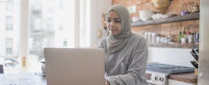 Muslim businesswoman working from home on her laptop